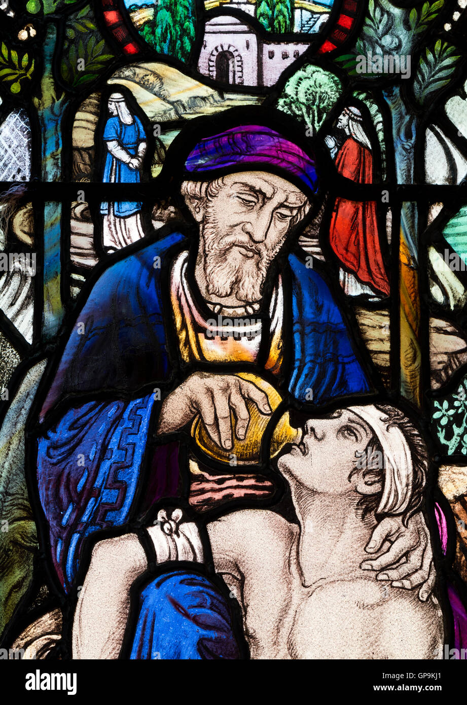 Good Samaritan stained glass by Albert Lemmon in St. Peter`s Church, Bengeworth, Evesham, Worcestershire, England, UK Stock Photo